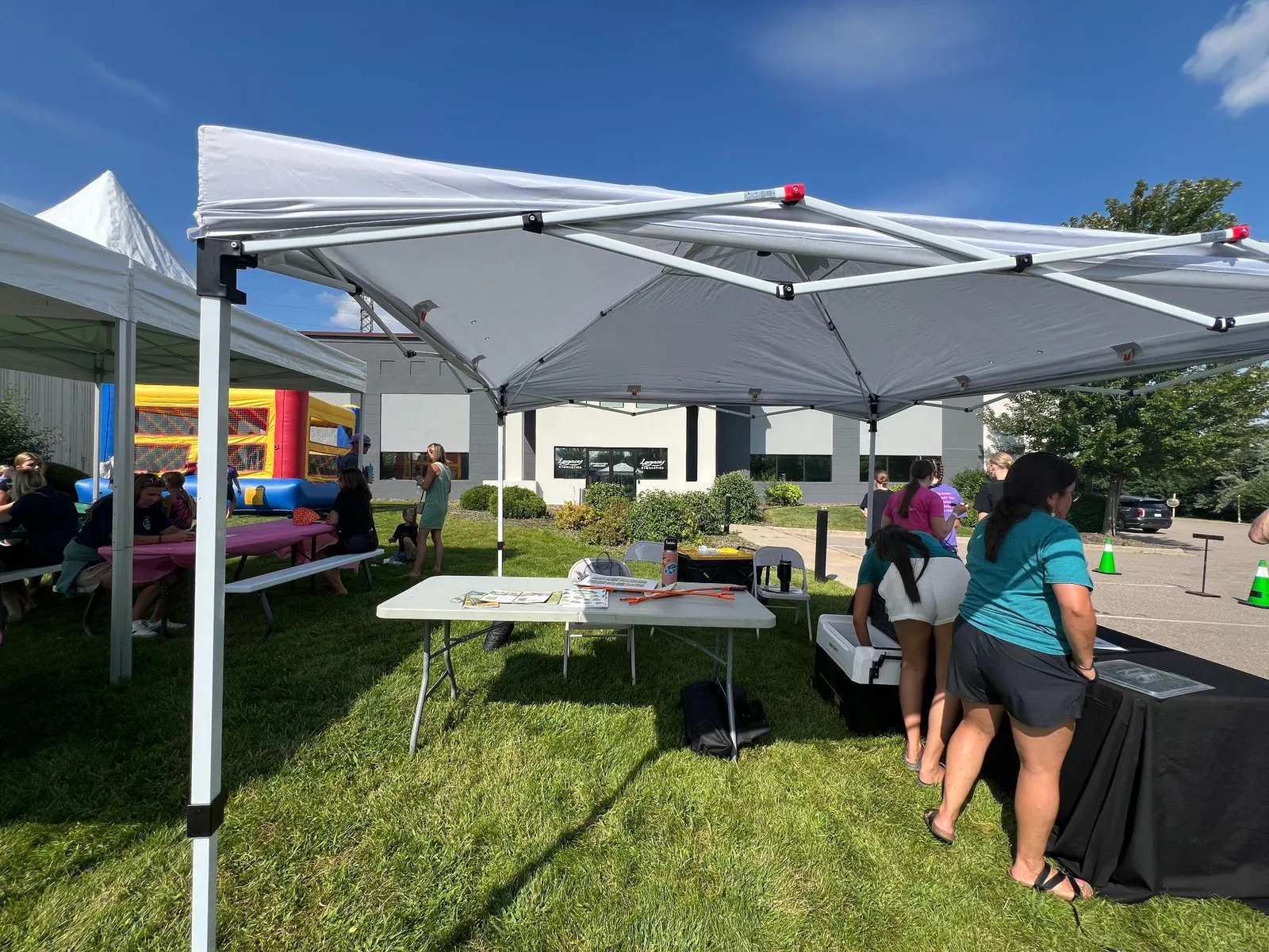RCC staff setting up an information table under a white canopy